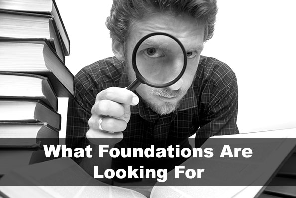 what foundations are looking for - man with magnifying glass