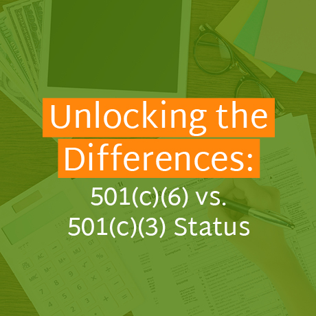 The article's title, "Unlocking the Differences: 501(c)(6) vs. 501(c)(3) Status," over someone writing on papers at a desk.